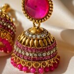 traditional pink stone gold plated jhumka earrings